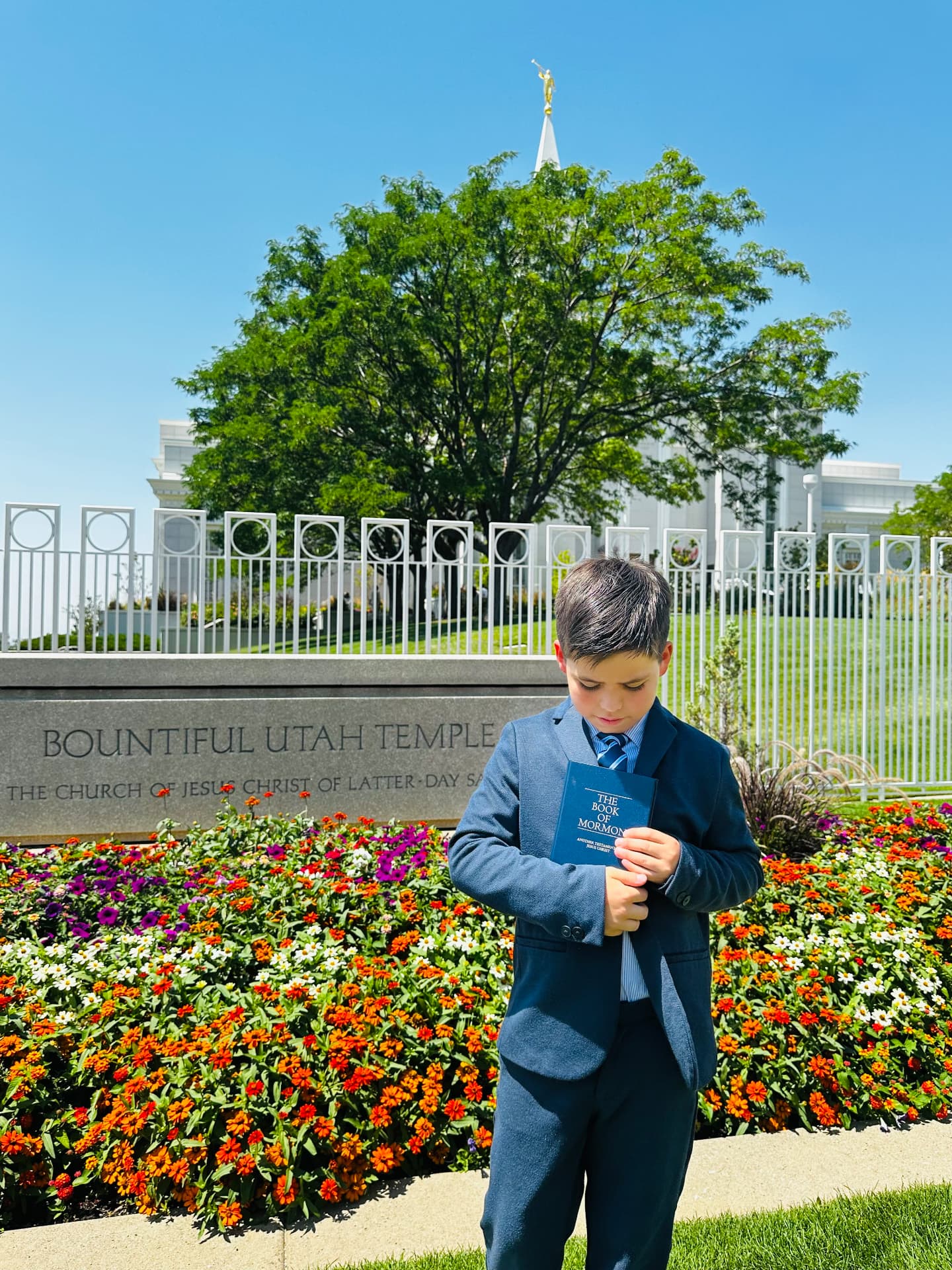 Oliver Anthony Martinez holding the Book of Mormon outside the Bountiful Utah Temple.