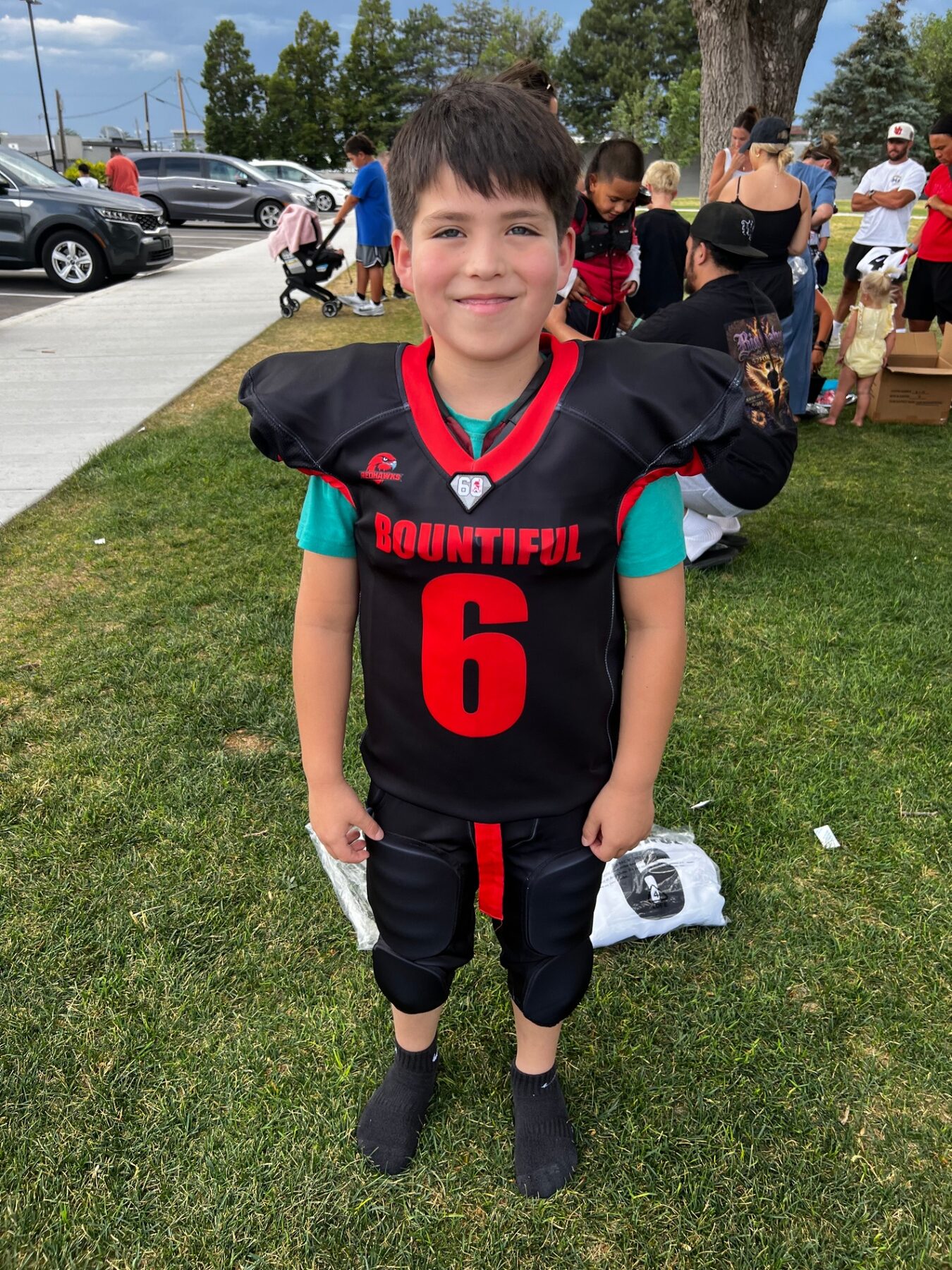 Oliver in his Bountiful Redhawks football uniform on the field.