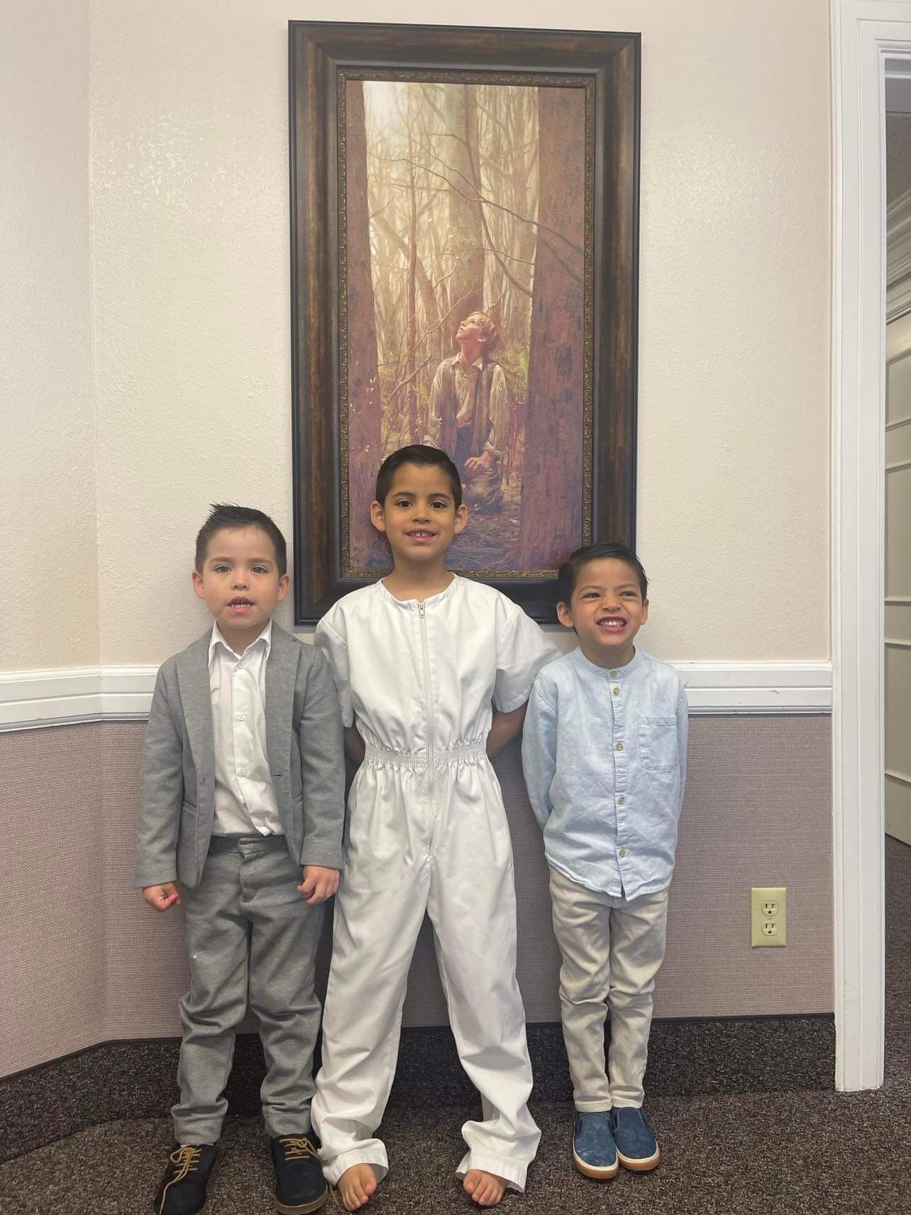 Oliver and two boys dressed for a baptism day.