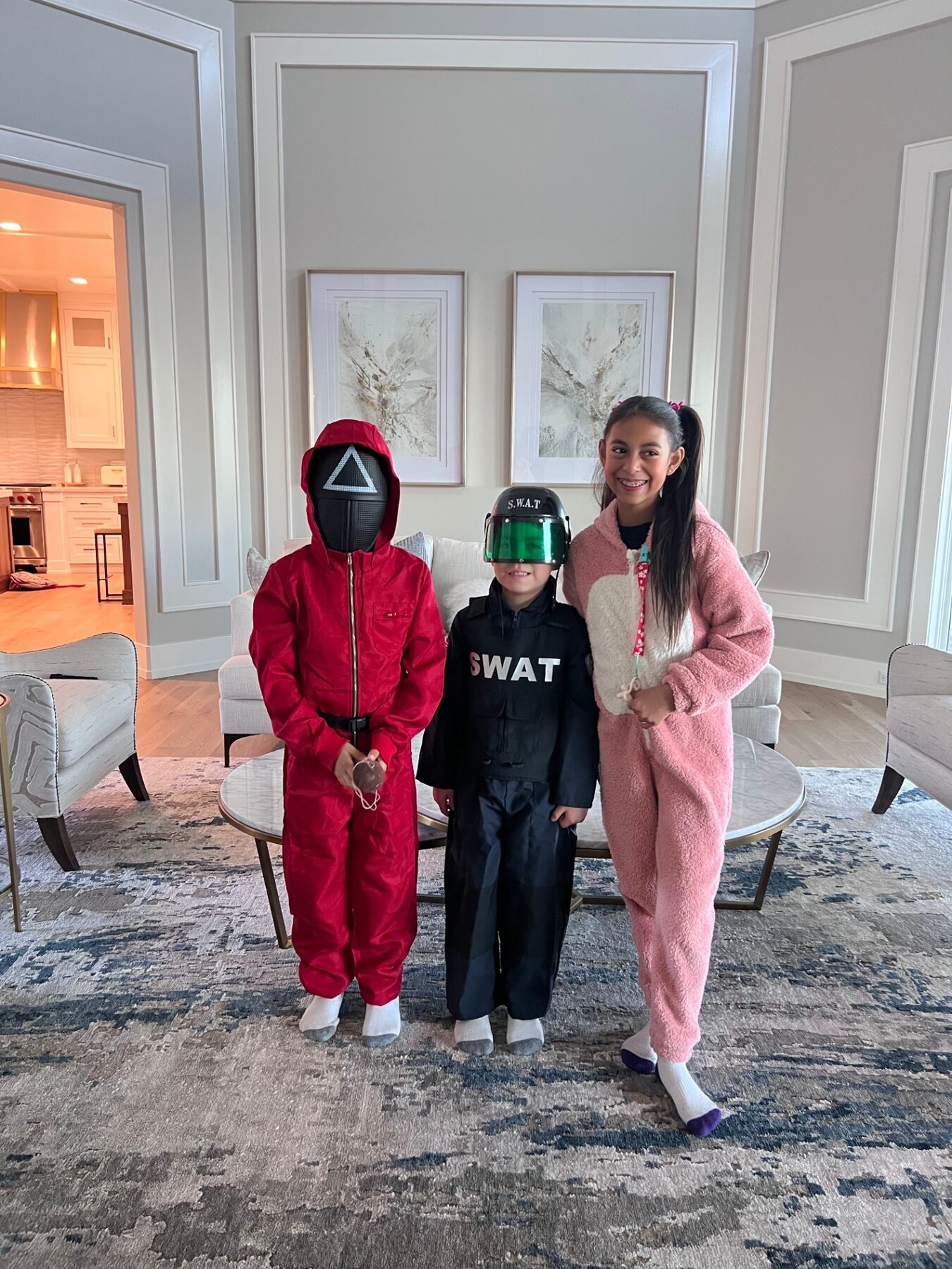 Oliver dressed in a SWAT costume with his siblings for Halloween.