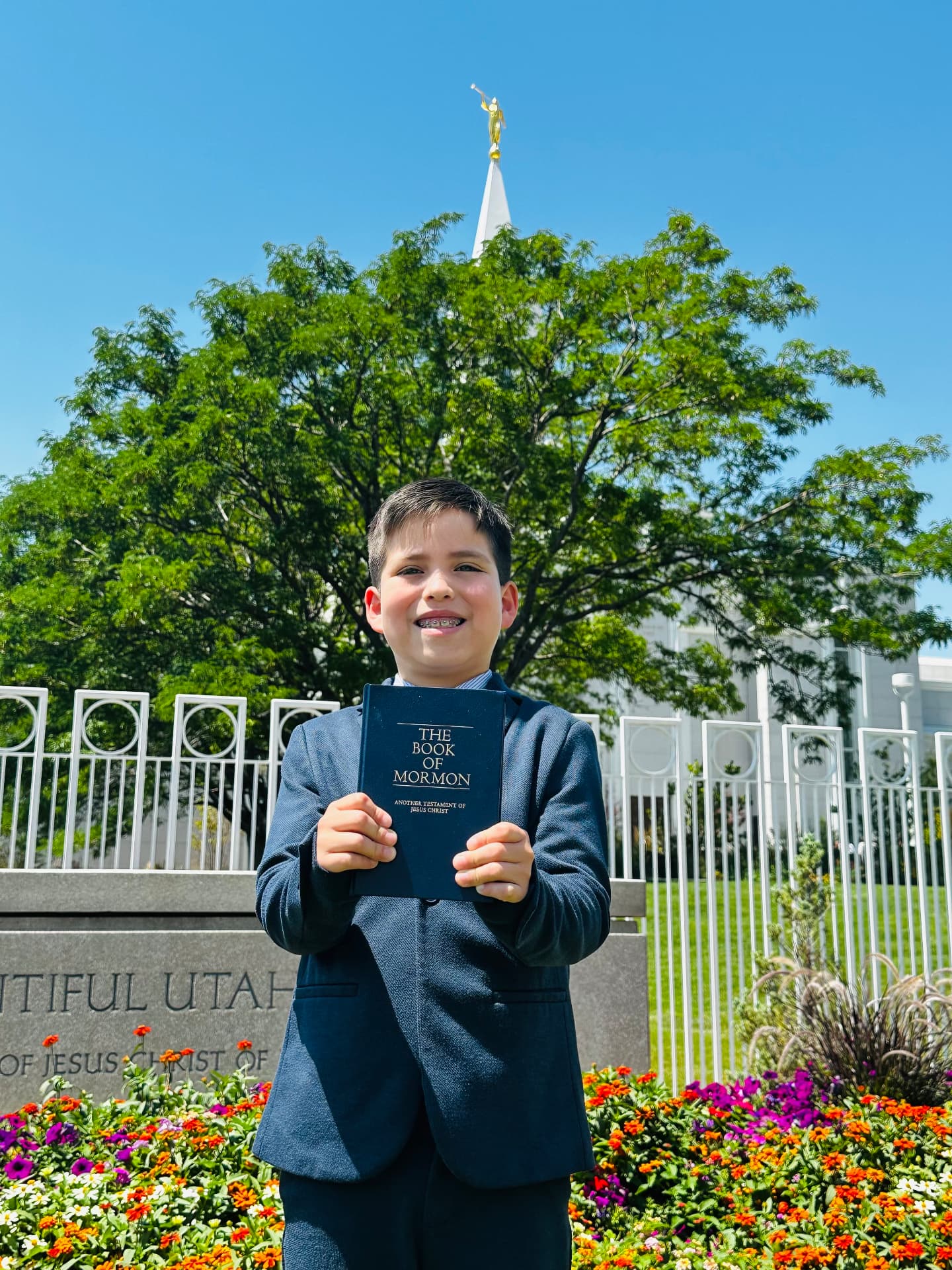 Oliver Anthony Martinez holding the Book of Mormon outside the Bountiful Utah Temple.