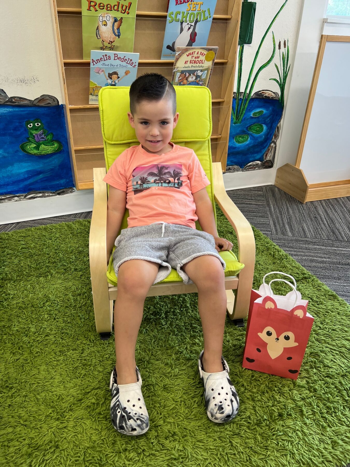 Oliver sitting in a classroom on a school day.